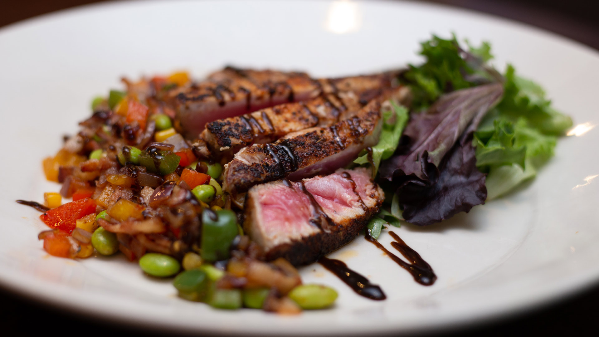 Sliced steak served with vegetables at Cristof’s